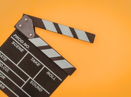 Clapperboard on orange background