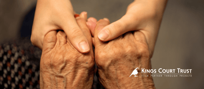 Holding hands - older person holding hands with a younger person