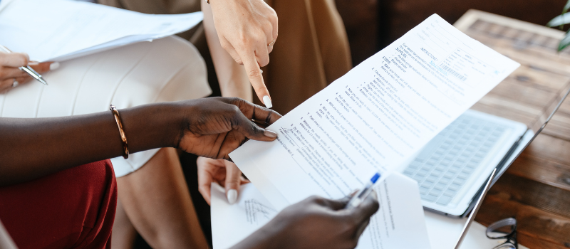 Two people reviewing a document