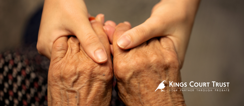 Holding hands - older person holding hands with a younger person